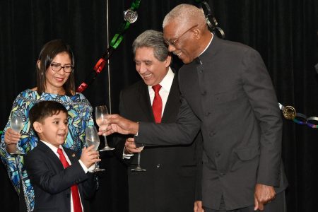 President David Granger (right) shares a toast with the son of Mexican Ambassador to Guyana, Jose Omar Hurtado Contreras (second from right) and the Ambassador’s wife Waleska Sarai Salinas Martinez.  The occasion was the observance of the 209th anniversary
of Mexican Independence. The event was held at the Marriott Hotel. (Ministry of the Presidency photo)
