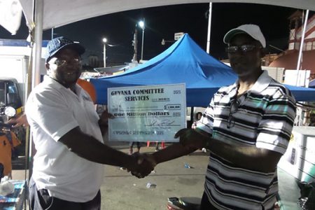 Junior Cornette emerged winner of the $1M grand prize. He is pictured receiving the ceremonial cheque from executive member of the GCS, Leslie Blacks.
