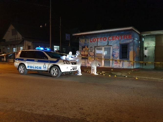 Crime Scene Investigators search for evidence at the scene where Haradath Solomon was gunned down on Saturday night.