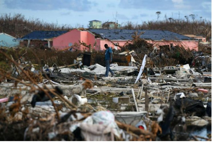 A man searches for belongings amongst debris in a destroyed neighborhood in the wake of Hurricane Dorian in Marsh Harbour, Great Abaco, Bahamas, September 8, 2019. REUTERS/Loren Elliott