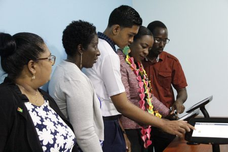 Minister Nicolette Henry (second from right) in the E-Library (Ministry of Education photo)