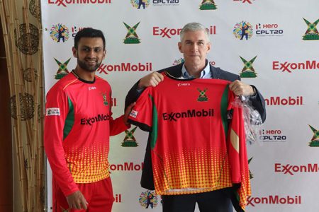 ExxonMobil’s Country Manager, Rod Henson (right) is presented with his Guyana Amazon Warriors kit (Romario Samaroo photo)