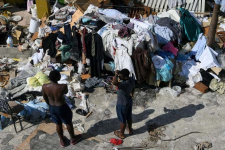 Young men work to salvage some of their belongings in a destroyed neighborhood in the wake of Hurricane Dorian in Marsh Harbour, Great Abaco, Bahamas, September 7, 2019. REUTERS/Loren Elliott
