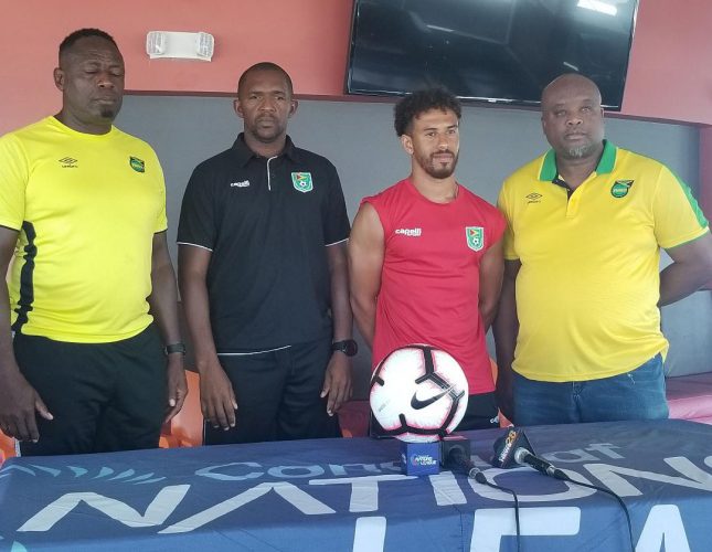 Calm before the storm-Reggae Boyz Assistant coach Jerome Waite [left] posing alongside Golden Jaguars Captain Sam Cox [2nd from left] and Assistant coach Charles Pollard [3rd from left] at the end of the pre-match press conference. Also in the photo is Team Manager James Pearson  
