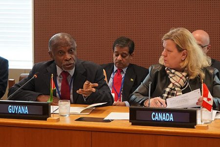 Guyana Foreign Secretary Carl Greenidge (left) speaking at the meeting. At right is Canada’s High Commissioner to the United Kingdom Janice Charette. (Commonwealth Secretariat photo)