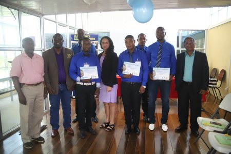 The managing directors of the two companies, Raymond Tawjoeram (left), Adrian Clarke (second from left), along with five of the graduates and one of the tutors, Sabrina Van Dyke (centre). (photo by Terrence Thompson) 