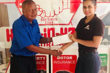Marketing Coordinator of Hand-in-Hand Mutual Fire and Life Insurance Companies, Shafeena Juman (right), presents the sponsorship cheque to coordinator Hassan Mohamed.