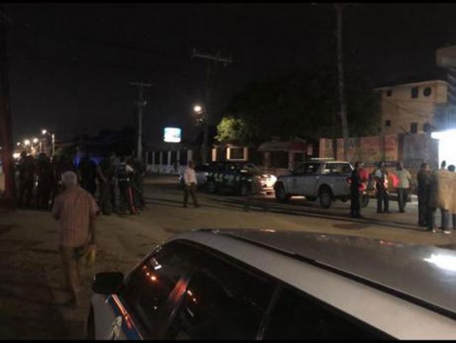 Police personnel gather outset the Cash Pot outlet during the reported robbery - Andre Williams photo