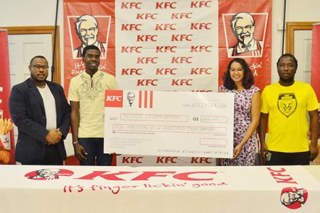 KFC Training Manager Charissa Rampersaud (2nd from right) handing over the sponsorship cheque to Petra Organization member Mark Alleyne in the presence of Petra Co-Director Troy Mendonca (left) and GFF representative Wayne Dover (right)
