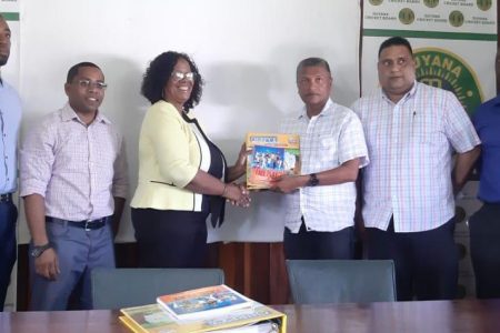 (l-r) Child Care and Protection’s Orette Francios, NSC TDO Seon Erskine, Allied Arts’ Lorraine Barker-King who is presented with the manual from Secretary of the GCB, Anand Sanasie, Treasurer of the GCB Anand Kalladeen and GCB TDO Colin Stuart.
