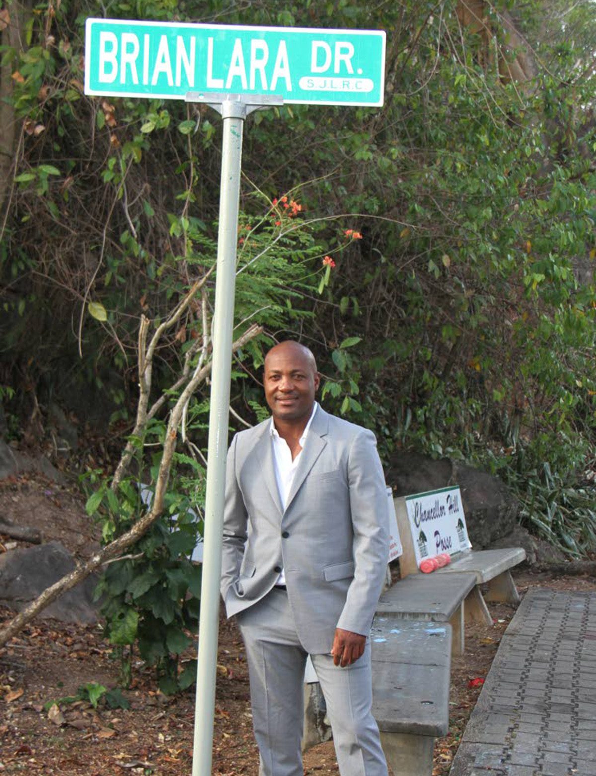 Cricket legend Brian Lara stands next to his own street sign at Chancellor Hill, Port of Spain on May 2. PHOTO BY ANGELO MARCELLE