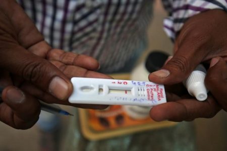 A health worker shows a malaria rapid test kit after collecting blood sample from a resident during a drive to prevent the spread of mosquito-borne diseases. REUTERS/Amit Dave/File Photo