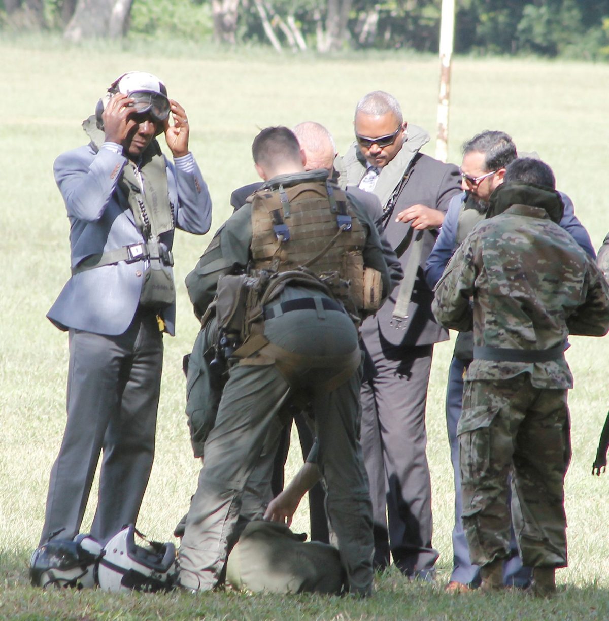 Prime Minister Dr Keith Rowley, left, US Ambassador Joseph Mondello, partly hidden and National Security Minister Stuart Young put on safety gear before boarding a helicopter at the Queen’s Park Savannah, Port- of-Spain, to attend the closing ceremony of the USNS Comfort at Gate A, Port of Brighton in La Brea, yesterday.