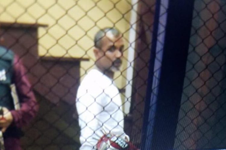 Roger Khan photographed while in police custody.