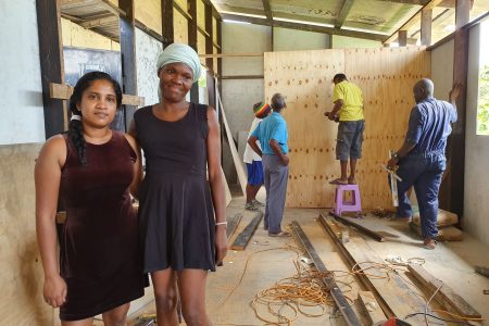 Church member Hayma Ali with Kathy Ann Devenish as work continues on her new home.