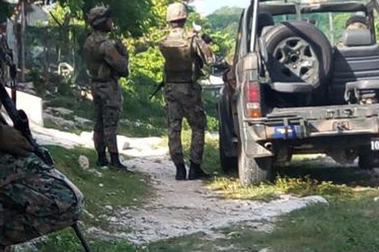 Jamaica Defence Force soldiers stand guard outside the house in Hollywood, Norwood, where six-month-old Tira Thompson was shot and killed and her mother shot and injured on Saturday.