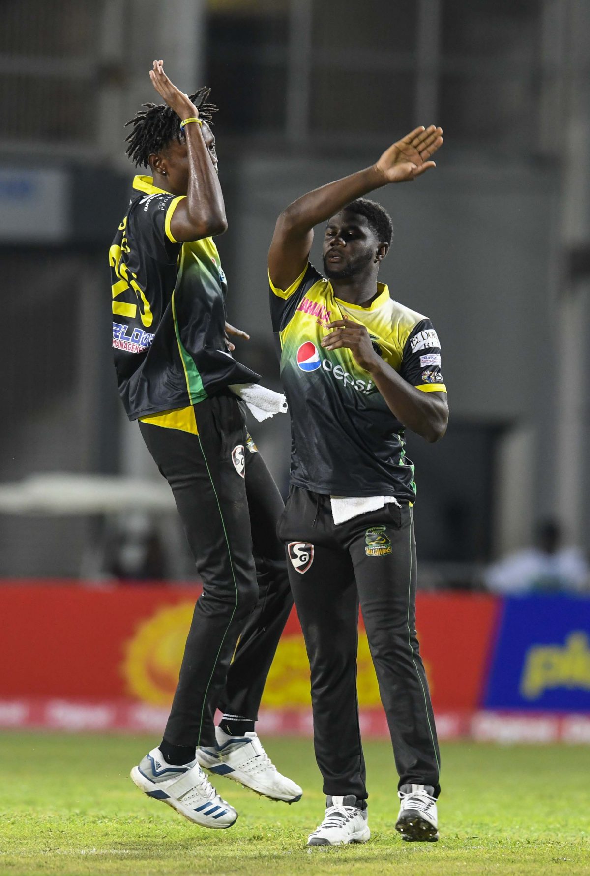 In this handout image provided by CPL T20, Ramaal Lewis (R) and Shamar Springer (L) of Jamaica Tallawahs celebrates the dismissal of John Campbell of St Lucia Zouks (not in frame) during match 9 of the Hero Caribbean Premier League between Jamaica Tallawahs and St Lucia Zouks at Sabina Park on September 12, 2019 in Kingston, Jamaica. (Photo by Randy Brooks – CPL T20/Getty Images)