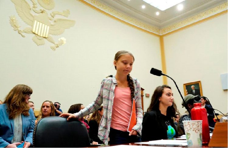 Sixteen year-old Swedish climate activist Greta Thunberg takes her seat to testify at a House Foreign Affairs subcommittee and House Select Climate Crisis Committee joint hearing on “Voices Leading the Next Generation on the Global Climate Crisis” on Capitol Hill in Washington U.S., September 18, 2019. REUTERS/Kevin Lamarque