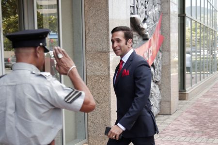 Attorney General Faria Al-Rawi is saluted by a police officer on his arrival to Parliament.