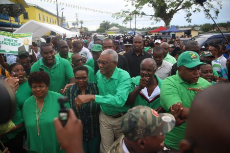 President David Granger and PNCR Chairperson Volda Lawrence and General Secretary Amna Ally make their way to the anniversary rally in Linden yesterday. (Terrence Thompson photo) 
