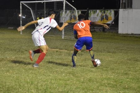 Nicholas MacArthur (No.10) of Fruta Conquerors on the attack against Timehri Panthers. 