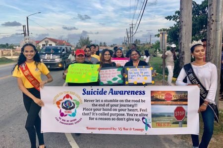 Persons participating in the suicide awareness walk that took place last month with Miss India Guyana 2019 Rashena Hanif and Miss Eco Guyana in lead.