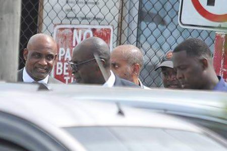 Former Education Minister Ruel Reid (second left) and Caribbean Maritime University President Professor Fritz Pinnock (left) about to enter the Corporate Area Parish Court in Half-Way-Tree, St Andrew, yesterday for a bail hearing. Both men, along with Reid's wife Sharen and daughter Sharelle, as well as Jamaica Labour Party Councillor Kim Brown Lawrence are facing multiple charges in a multimillion-dollar fraud case. (Photo: Garfield Robinson)