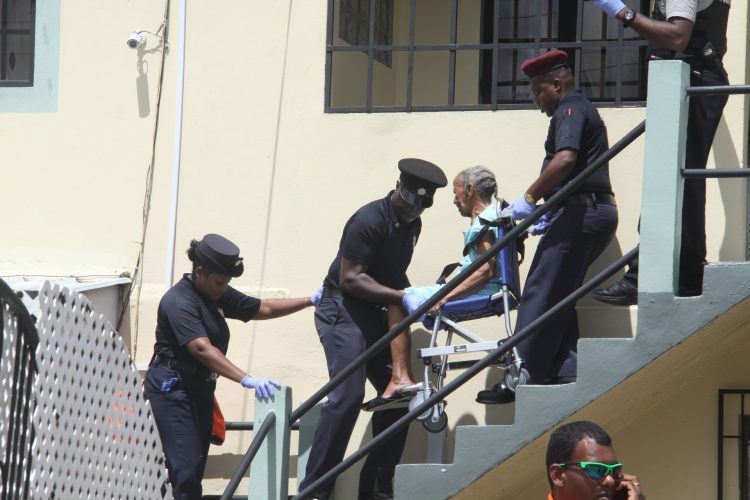 Shiela Hall who was a resident at a home for the aged, is removed by fire officers, yesterday, after a family member complained that the owners were not letting her leave.