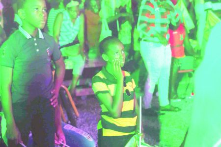 Their faces tell the story: Young Guyana Amazon Warriors (GAW) supporters react to the team’s loss in the finals of the Caribbean Premier League (CPL) at the government-sponsored Watch Party, held at the D’Urban Park last night. (Photo by Terrence Thompson) 