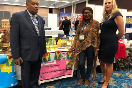 President of Guyanese- American Chamber of Commerce  Wesley Kirton (left)  with US Food and Drug Administration official Kim Prenter (right) and Guyanese  participant in the Trade Fair Anne Peters- Bristol