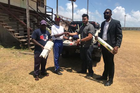Director of Sport, Christopher Jones (extreme right) and West Indian Sports Complex owner, Javed Khan (second from right) hands over the gear to representatives of Buxton SC.
