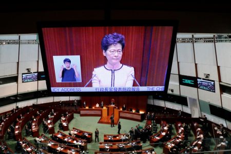 Hong Kong Chief Executive Carrie Lam is seen on a screen as she reacts to protests by pro-democracy lawmakers, at the Legislative Council in Hong Kong, China, October 16, 2019. REUTERS/Tyrone Siu