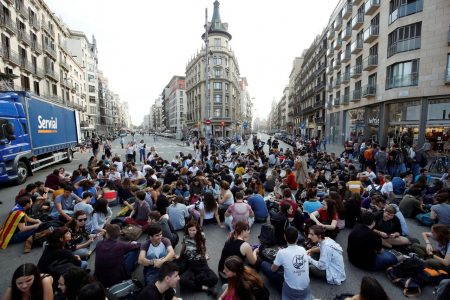 Students sit at Plaza Universidad after a verdict in a trial over a banned independence referendum, in Barcelona, Spain October 14, 2019. REUTERS/Albert Gea