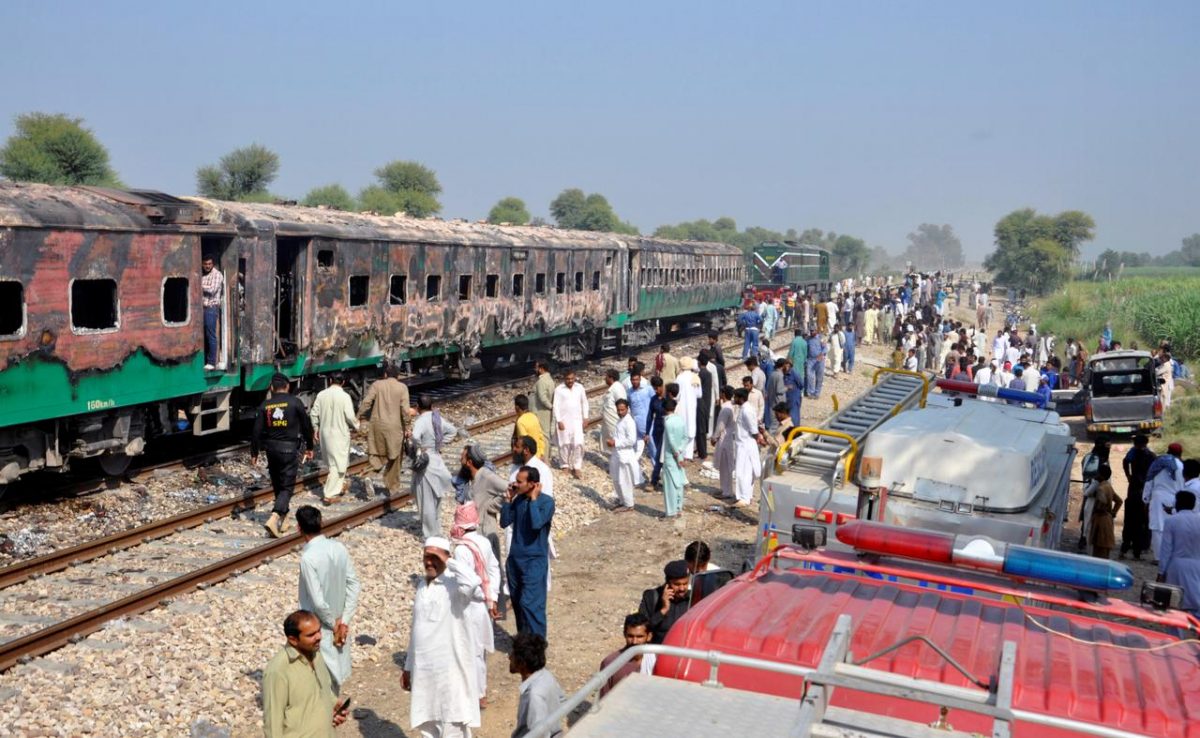People gather at the place where a fire broke out in a passenger train and destroyed three carriages near the town of Rahim Yar Khan, Pakistan October 31, 2019. REUTERS/Stringer