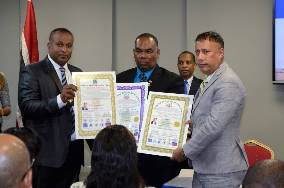 Police Commissioner Gary Griffith receives certificates for an hororary degree and other awards from the University for Global Peace and the Academy for Universal Global Peace USA during a ceremony at Queen’s Park Oval, Port of Spain on September 5. Questions are being raised about the accrediation of the organisations.