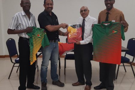 GOA President, K. A Juman Yassin (2nd right) hands over one of the track suits to Full-bore VC Dylan Fields in the presence of team members Ryan Sampson (right) and Ransford Goodluck.    
