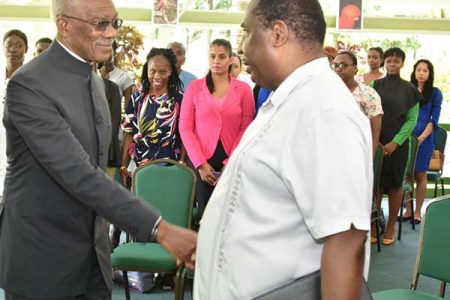 President David Granger (left) greets President of the Guyana Public Service Union, Patrick Yarde at the opening. (Ministry of the Presidency photo)
