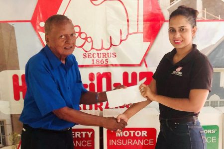 Marketing Coordinator of Hand-in-Hand Mutual Fire and Life Insurance Companies, Shafeena Juman (right), presents the sponsorship cheque to coordinator Hassan Mohamed.

