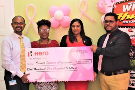 Dr. Sayan Chakraborty (left) receives the donation from Deon Williams (right) in the presence of Monette Harry (second left) and Kamla Mohan.
