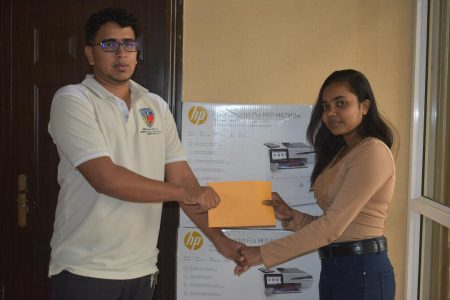 Ink Plus’ Customer Service Representative Reama Sookdeo (right) hands over her company’s sponsorship to Treasurer of the GSCL Russell Jubeer  