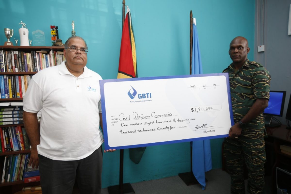 In photo GBTI Executive Director Richard Isava (left) presents the funds raised from the GBTI Hurricane Relief Fund- Bahamas to Director General of the Civil Defence Commission Col. Kester Craig at the CDC's office.  (GBTI photo)