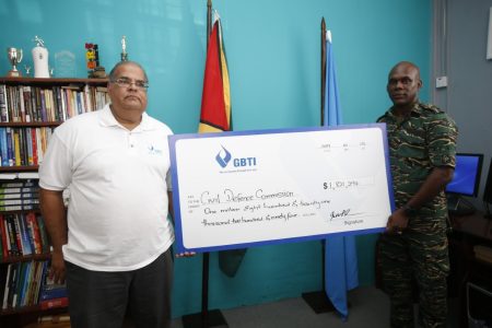 In photo GBTI Executive Director Richard Isava (left) presents the funds raised from the GBTI Hurricane Relief Fund- Bahamas to Director General of the Civil Defence Commission Col. Kester Craig at the CDC’s office.  (GBTI photo)