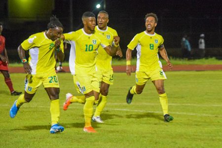 Some members of the Golden Jaguars team celebrating the  second goal scored by Trayon Bobb against Antigua and Barbuda in League-B of the CONCACAF Nations League at the National Track and Field Center, Leonora last night.