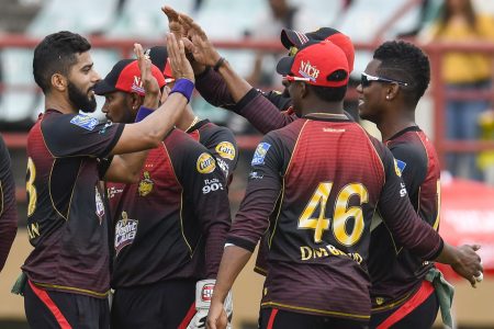 Ali Khan (L) of Trinbago Knight Riders celebrates the dismissal of Mohammad Hafeez of St Kitts and Nevis Patriots at the Guyana National Stadium yesterday. (Photo by Randy Brooks - CPL T20 via Getty Images)