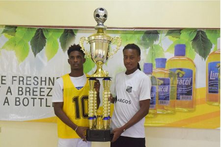 Opposing captains-Nicholas MacArthur [left] of Fruta Conquerors U20 and Marcus Wilson of Santos U20 pose with the coveted Limacol Football Championship trophy