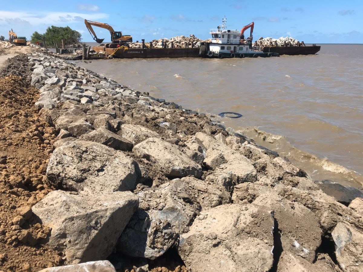 A boulder-laden barge on site at Fairfield, where works are ongoing to repair the breached sea defence. (Photo by David Papannah)