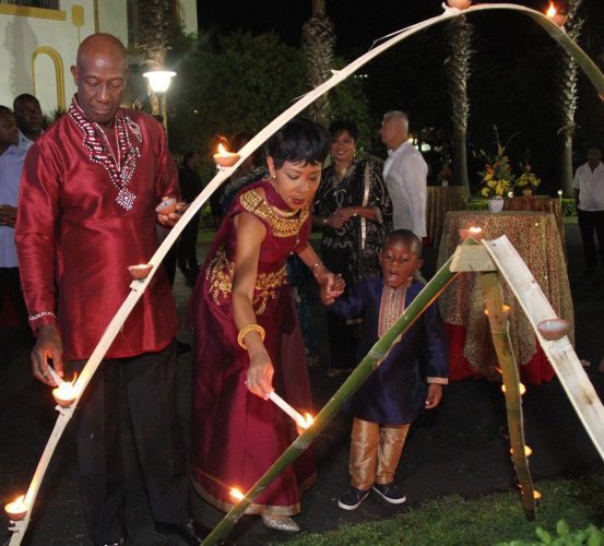 Trinidad & Tobago Prime Minister Dr Keith Rowley, his wife Mrs Sharon Rowley and their grandson light deyas at the Diplomatic Centre