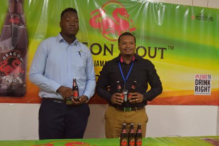 Dragon Stout brand coordinator Jamal Baird (left), and Communications Officer Treiston Joseph posing for a photo opportunity at the official launch of the inaugural Dragon Stout ‘Community Cup’ Street-ball Championship