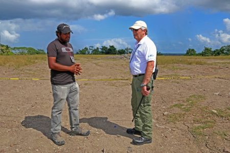 Geologist Xavier Moonan, left, and ODPM regional coordinator Eric Mackie at the mud volcano in Piparo on Sunday. PHOTO BY MARVIN HAMILTON