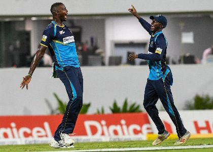 Tridents captain Jason Holder (left) celebrates with match-winner Hayden Walsh during their win over St Lucia Zouks. (Photo courtesy CPL)